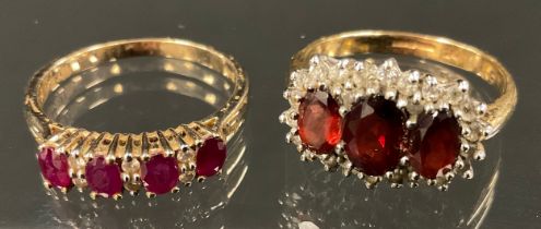 A ruby and diamond ring, linear set with four oval red rubies divided by pairs of diamond accents,