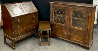 An Old Charm style oak, glazed bookcase, 98.5cm high x 107cm wide x 33.5cm deep; Stanley Wood oak