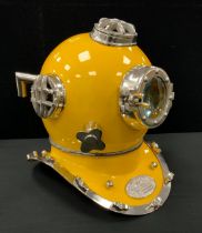 A reproduction novelty yellow divers helmet, marked ‘US NAVY DIVING HELMET’, 43cm high