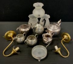 A Silverplated three piece tea set, four piece pewter tea set, pair of brass single branch wall