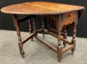 A George III oak drop-leaf dining table, oval top, single drawer to frieze, 71cm high x 103cm x 43cm