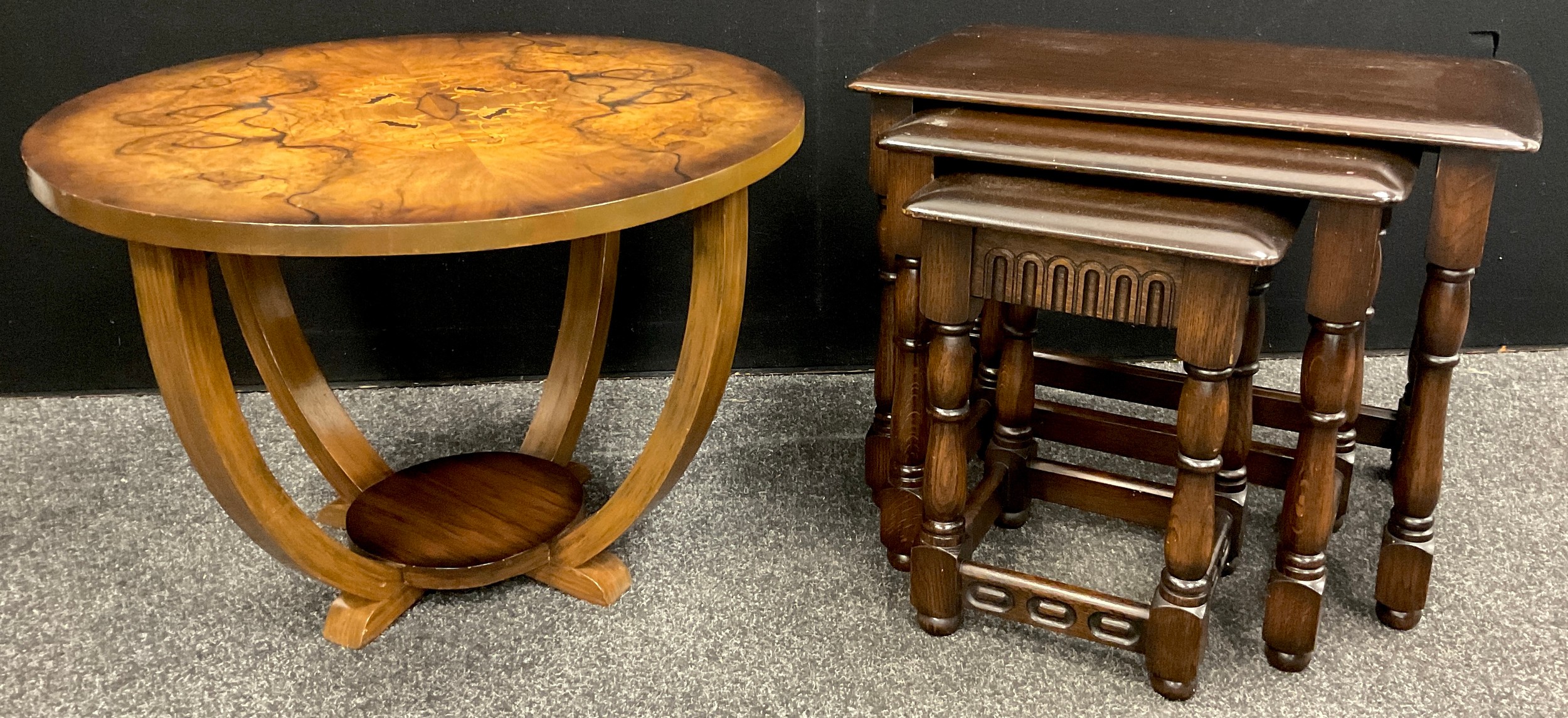 An Art Deco style inlaid walnut occasional table, 46cm high x 64.5cm diameter; a Priory oak nest
