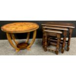 An Art Deco style inlaid walnut occasional table, 46cm high x 64.5cm diameter; a Priory oak nest