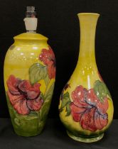 A Moorcroft pottery Hibiscus pattern lamp base, yellow ground, 27cm high, similar taller baluster