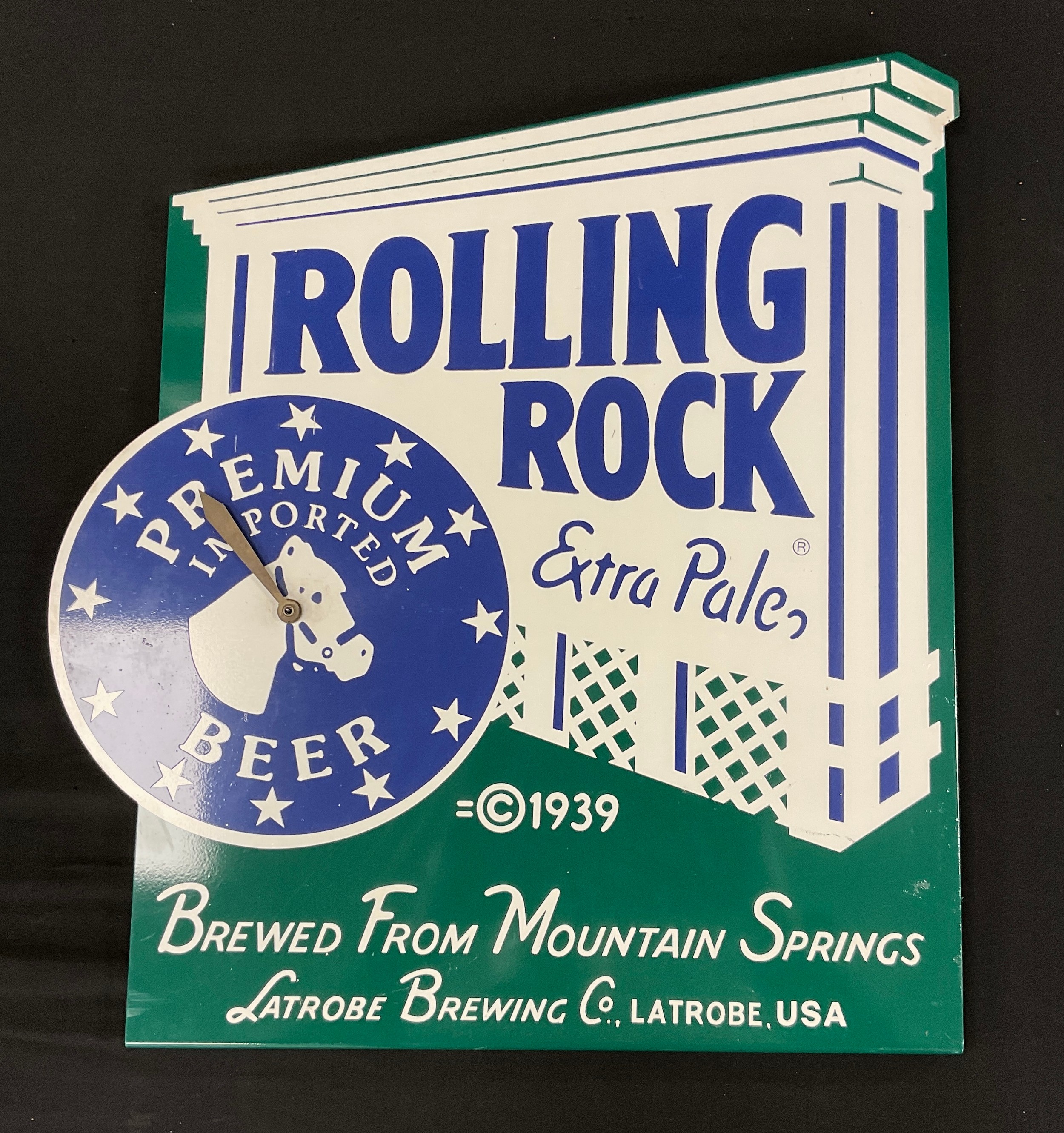 A reproduction 'Rolling Rock Premium Imported Beer' enamel advertising timepiece, with battery