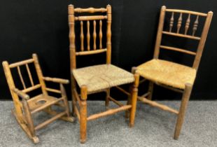 A childs stick back rocking chair, turned arms, slope back seat; 19th century rush seated side chair