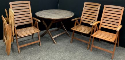 Garden furniture - a circular hardwood garden table, 75.5cm high x 111cm diameter; a conforming