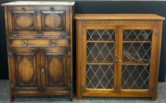 An old charm style oak cocktail cabinet, 122cm high x 81cm wide x 47cm deep; an old charm style