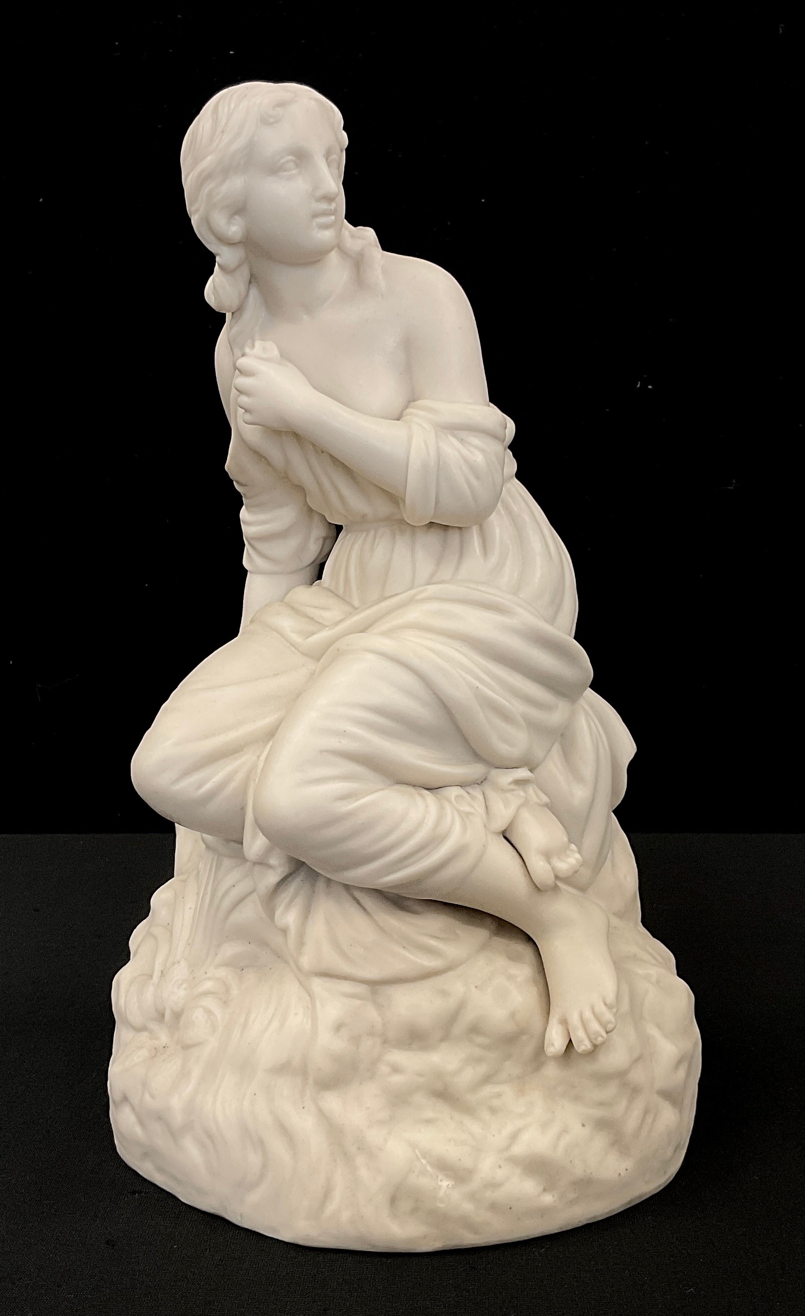 A Parian ware figure of a seated maiden, 23cm high.