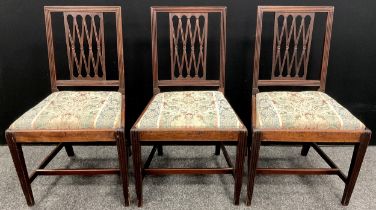 A set of three George III mahogany dining chairs.