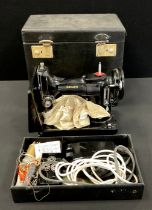 A Singer Sewing Machine, model 221K1, or similar, in original case, manufacture number 194144-001.