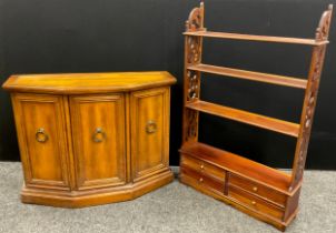 A mahogany wall-mounted four tier shelf, with four short drawers to base, fretwork sides, 113cm high