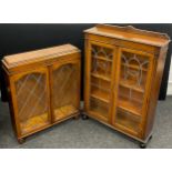 An early 20th century oak bookcase cabinet, quarter galleried top, carved decoration to frieze,