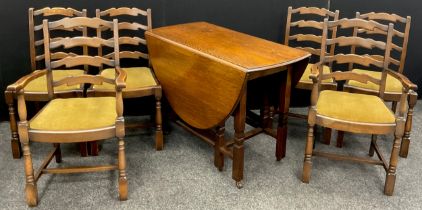 An early 20th century oak drop-leaf dining table, and set of four elm and oak ladder-back dining