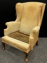 A Parker Knoll wing-back armchair.