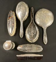 An Edwardian silver and tortoiseshell six piece dressing table set, scent bottle, hand mirror,
