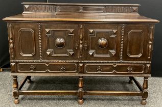 An early 20th century Jacobean Revival oak sideboard, by Greenlands of Hereford, 108cm high x