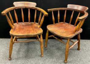A pair of early 20th century elm and stained beech smoker’s bow armchairs, each measuring 78.5cm