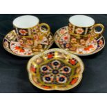 A pair of Royal Crown Derby 2451 ‘Old Imari’ coffee cans and saucers, 1128 trinket tray (3)