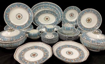 A Wedgwood ' Florentine' pattern dinner service for eight comprised of;a set of three graduated meat