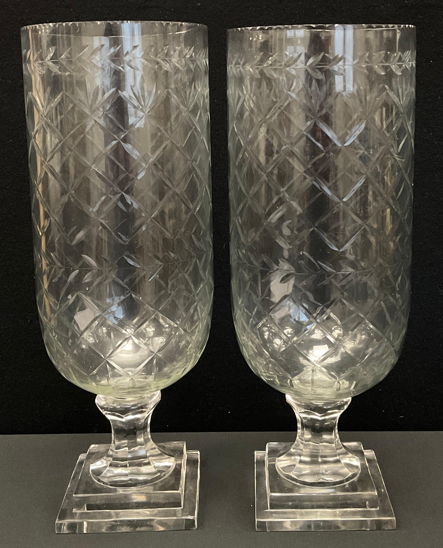 A pair of modern cut glass hurricane lamps, on square base, 40cm high (2)