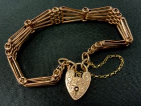 A 9ct rose gold tapering fancy bar gate bracelet, pad lock clasp, 1.3cm wide, 19.4g
