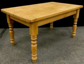 A pine farmhouse kitchen table, 78.5cm high x 149cm long x 90.5cm wide.