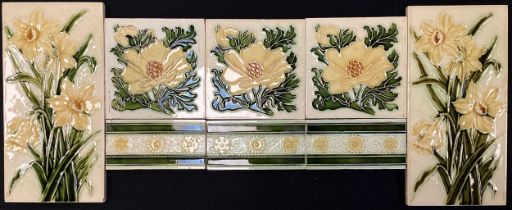 A group of eight Pilkington majolica tiles, flowers and stripes, 15.5cm x 15.5cm,c.1900