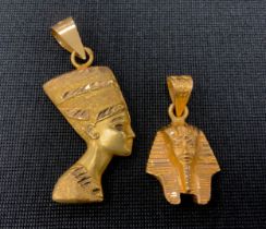 An Egyptian yellow metal pendant, as a Sarcophagus Mask, indistinctly marks, 6.8g; another