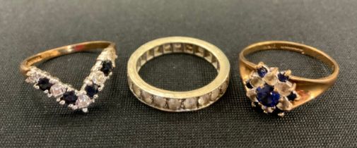 A 9ct gold sapphire and diamond effect V ring; similar cluster ring, 5.3g gross, white metal half