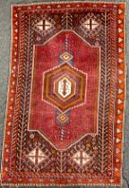 A Persian style woollen rug / carpet, hand-knotted with central hexagonal medallion, within