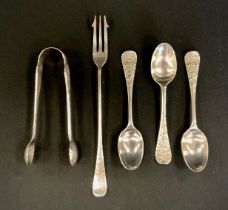 A pair of Victorian silver sugar tongs, and three spoons, cast with Swans, Serpents and floral
