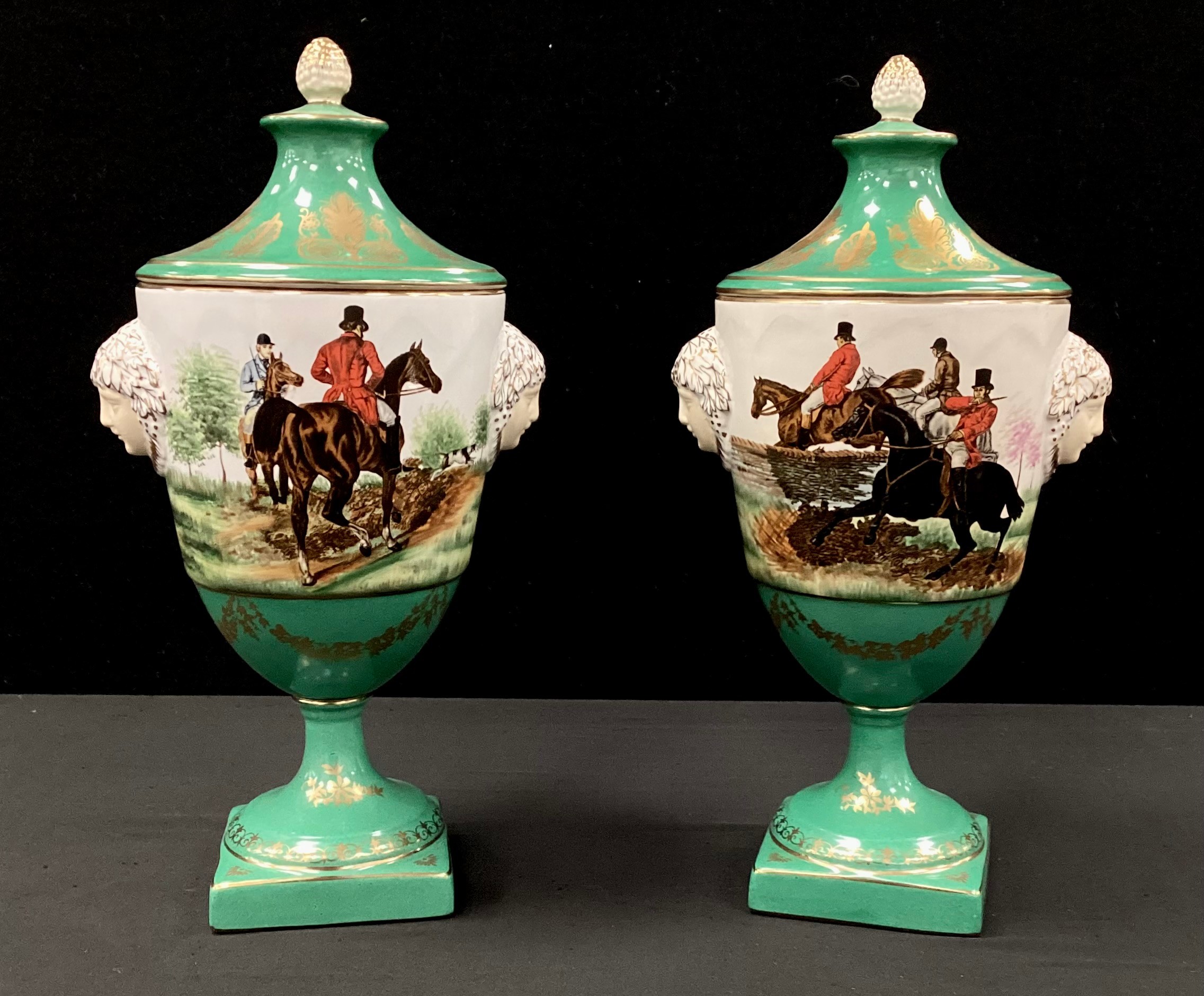 A pair of green hunting scene lidded urns, gilded detail, faux Sevres mark, 30cm (2)