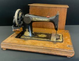 A Singer hand crank sewing machine, reg.no S1590643, 55cm long,c.1900