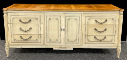 An Empire style sideboard, marquetry veneered walnut top, above central pair of cupboard doors, with