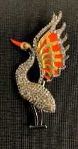 An Art Deco style diamond, ruby and enamel pendant brooch, as a fanciful wading bird, with orange