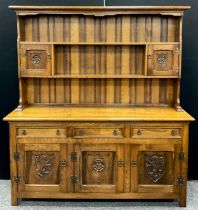 A Tudor inspired oak dresser, by Fletcher Mayfield, model number 56/63, 183.5cm high x 167.5cm
