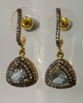 A pair of aquamarine and diamond earrings, central trilliant cut aquamarine surrounded by a double