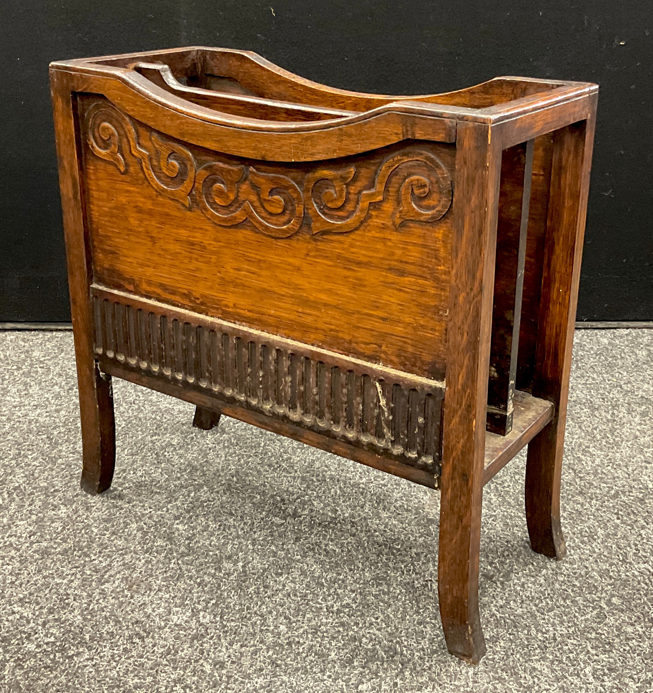 An Arts and Crafts oak armchair, c.1920; an early 20th century oak periodical rack, c.1930 (2) - Image 3 of 3