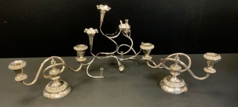 An Art Nouveau silver plated table centre epergne/posy holder; pair of two branch candlesticks (3)