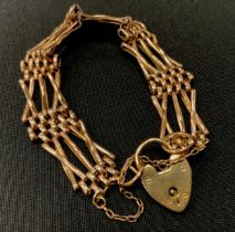 A 9ct gold X bar cross link gate bracelet, padlock clasp, 1.5cm wide, 18.1g