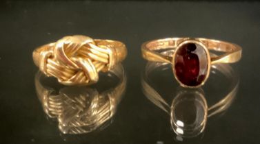An 18ct gold tied rope ball ring, Birmingham 1897, size N, 3.3g; 9ct rose gold and garnet oval