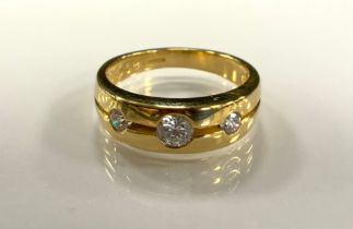 A diamond ring, tapering lined band set with three graduated round brilliant cut diamonds, total