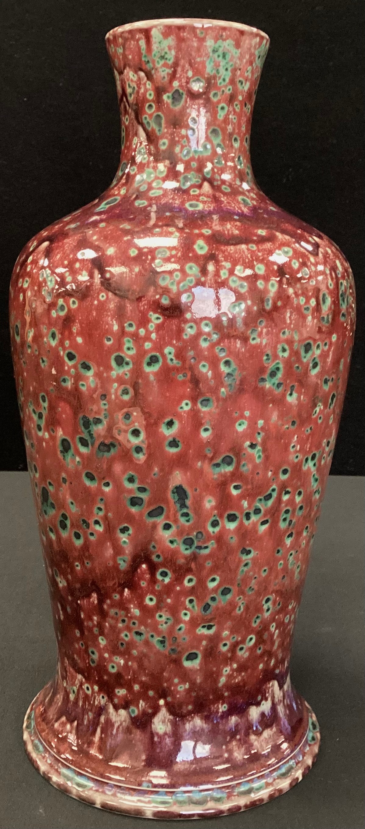 A Cobridge Stoneware Justin Emery Alchemist red mottled bottle vase, impressed marks, 31.5cm high.