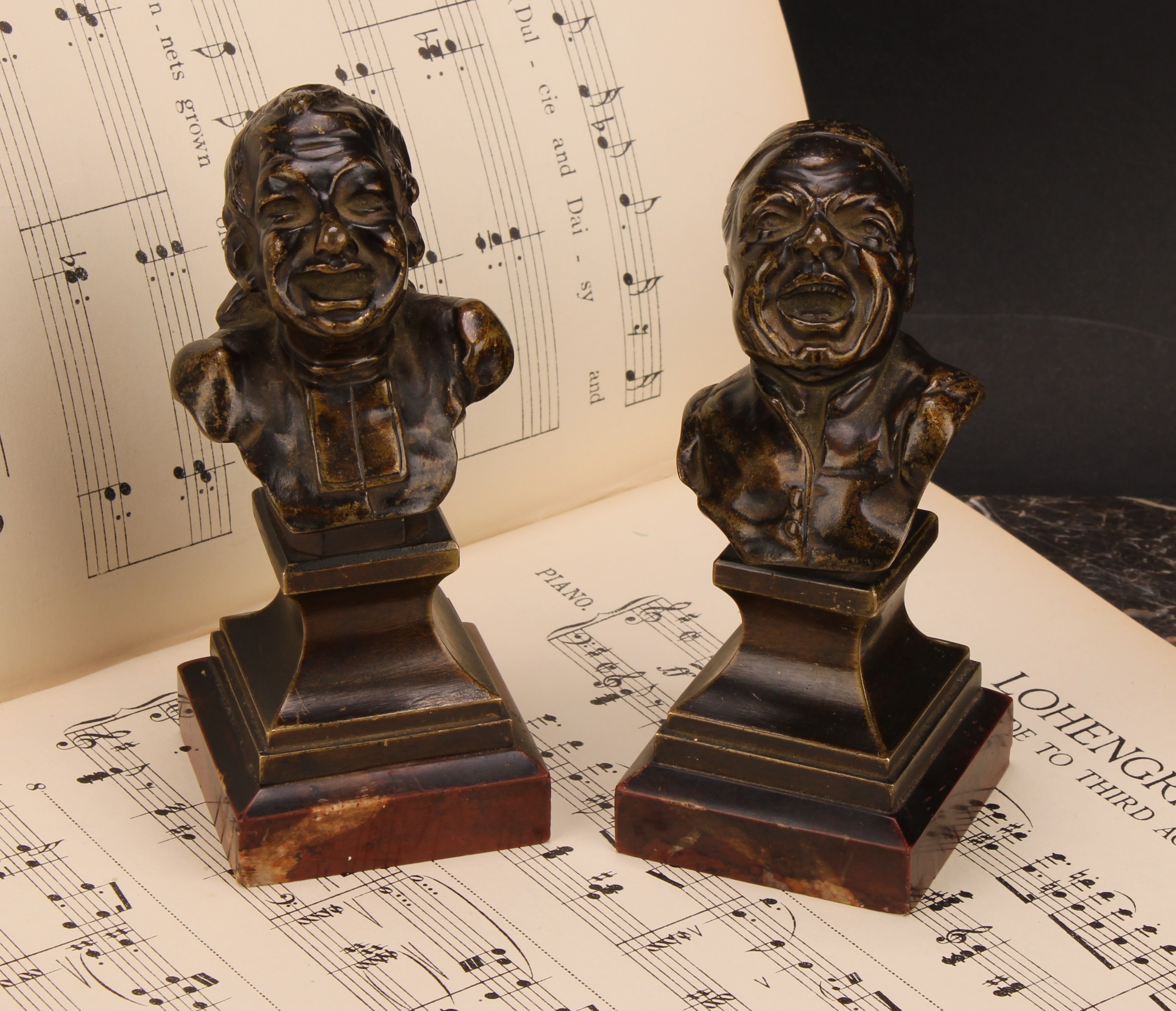 Continental School (19th century), a pair of bronze character heads, cast in the manner of Franz