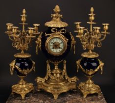 A late 19th century French gilt metal and porcelain clock garniture, 8cm circular dial inscribed