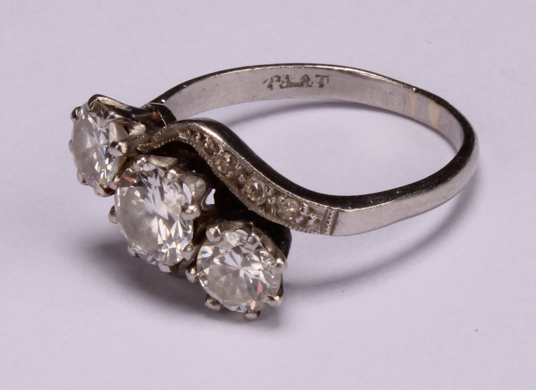 A diamond and platinum three stone twist ring, the central round brilliant cut stone flanked by - Image 3 of 4