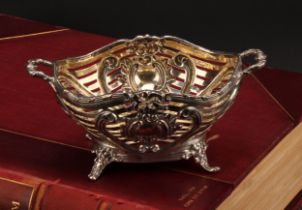 A Victorian silver sweetmeat basket, pierced and embossed with ribbons, scrolls and vacant