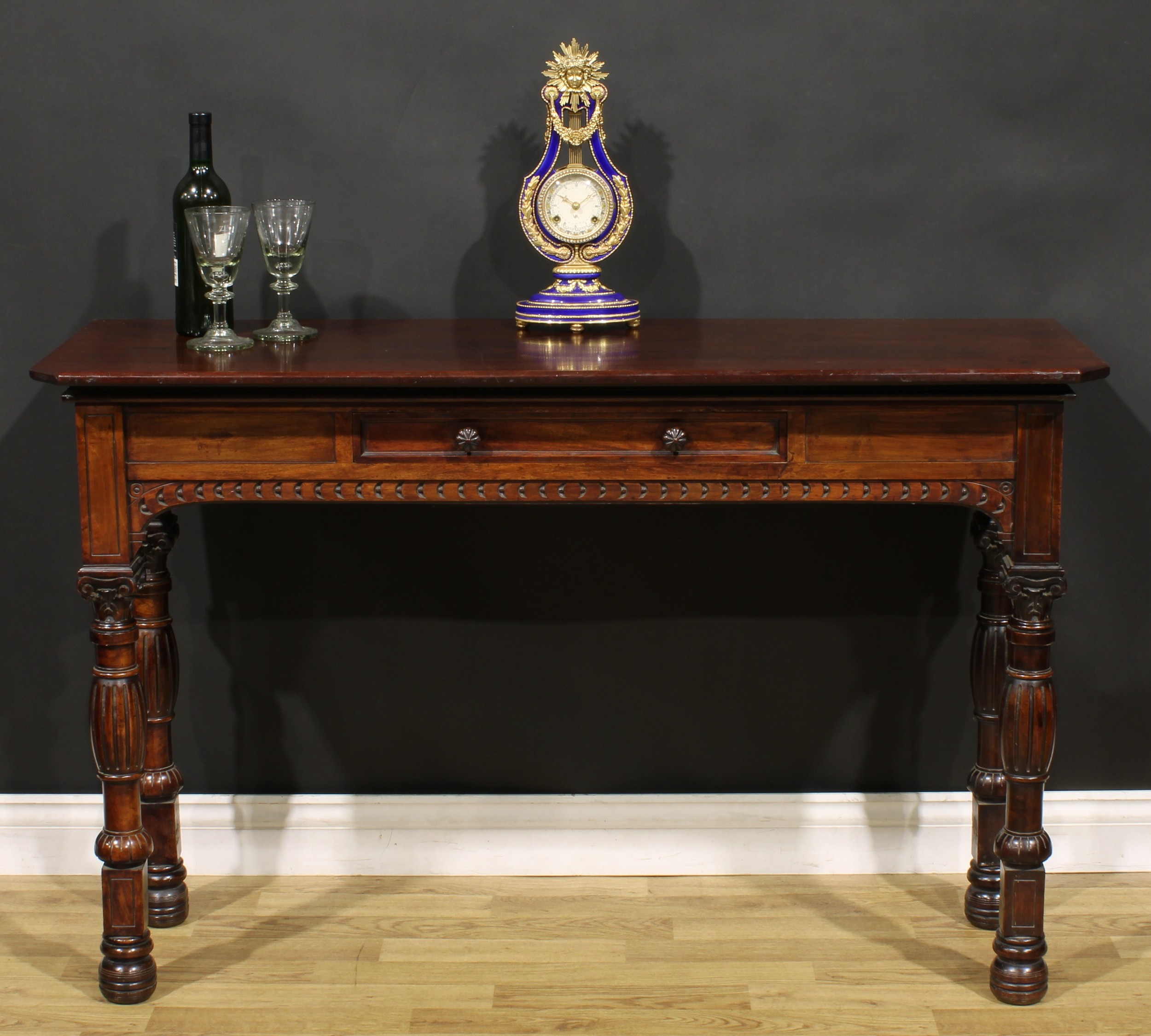 A Victorian mahogany pier table, rectangular top with canted foreangles above a single frieze