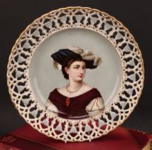 A Continental porcelain shaped circular charger, painted and printed with a portrait of a young lady